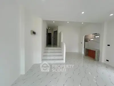 Spacious modern interior with marble flooring and elegant lighting, perfect for stylish living.