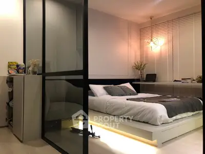 Modern bedroom with sleek glass partition and ambient lighting