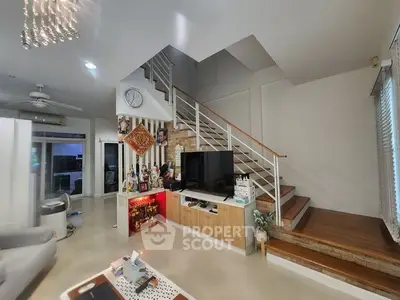 Spacious modern living room with stylish staircase and TV setup