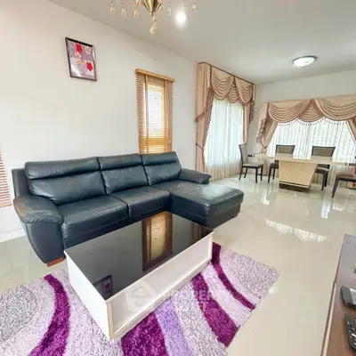 Spacious living room with elegant decor and modern furniture, perfect for family gatherings.