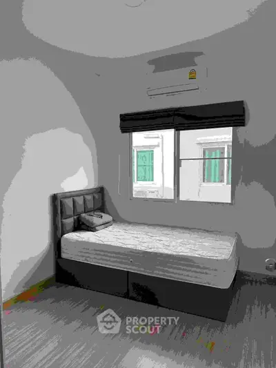 Cozy bedroom with single bed and air conditioning, perfect for a minimalist lifestyle.