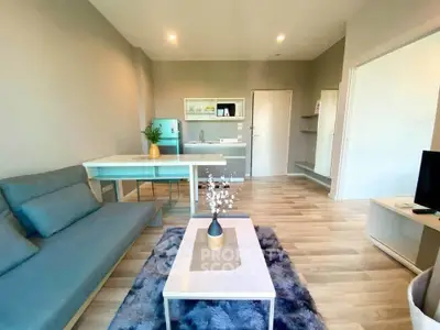 Modern living room with sleek furniture and open kitchen layout