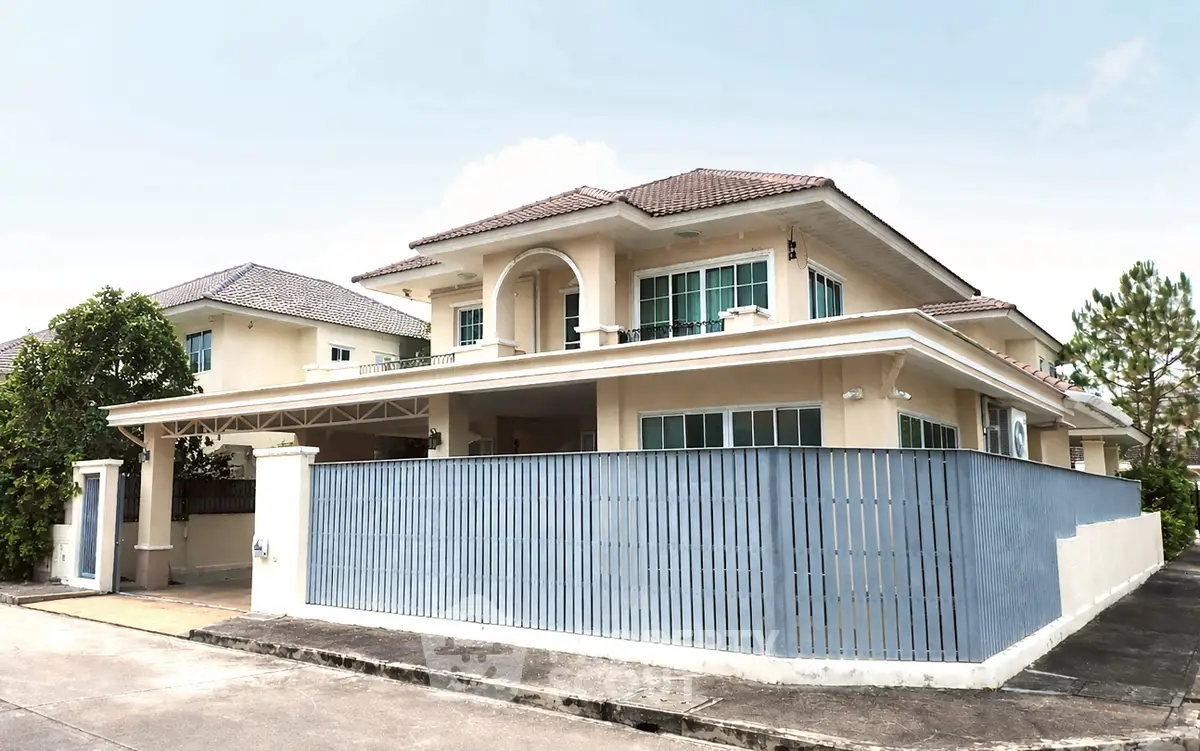 Elegant two-story house with modern architecture and spacious fenced yard in a serene neighborhood.