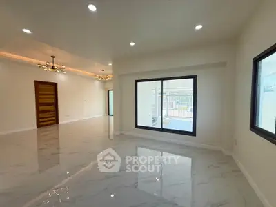 Spacious modern living room with elegant lighting and large windows