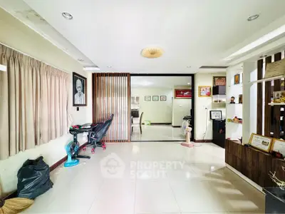 Spacious living room with modern decor and ample natural light, perfect for family gatherings.