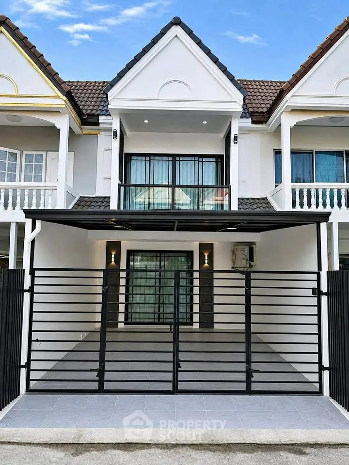 Charming townhouse with modern facade and gated entrance, perfect for family living.