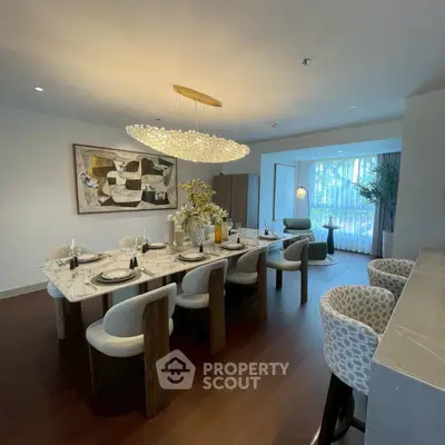 Luxurious dining room with elegant marble table and modern chandelier in upscale apartment.