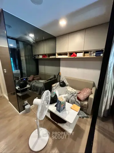 Cozy modern living room with mirrored wall and stylish decor