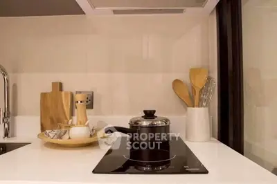 Modern kitchen with sleek induction cooktop and stylish utensils