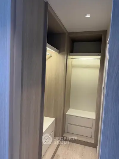 Spacious walk-in closet with modern wooden finish and ample storage space.