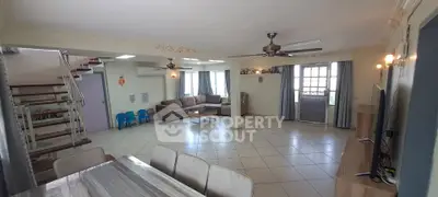 Spacious living room with modern decor and ample natural light