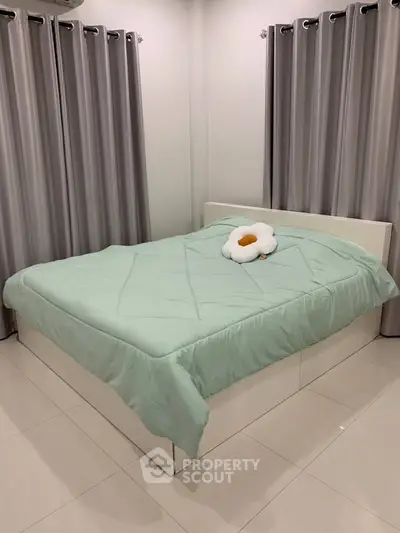 Cozy bedroom with modern decor and plush bedding in a serene setting.