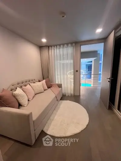 Chic modern living room with elegant sofa and plush decor, featuring a cozy ambiance and stylish design.