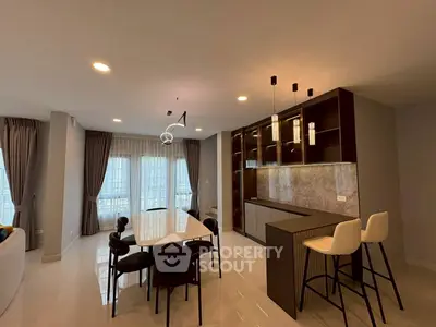 Modern dining area with elegant lighting and open layout in luxury apartment