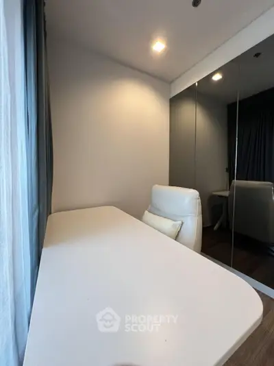 Modern study room with sleek white desk and comfortable chair