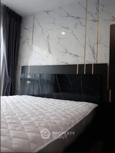 Luxurious bedroom with marble accent wall and elegant bedding