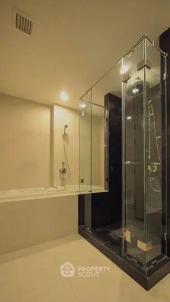 Luxurious modern bathroom with glass shower and bathtub in elegant design.