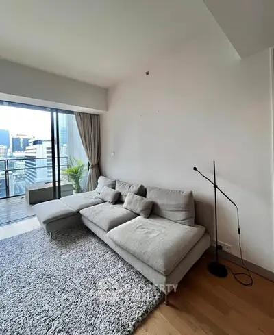 Modern living room with cozy sofa and city view balcony