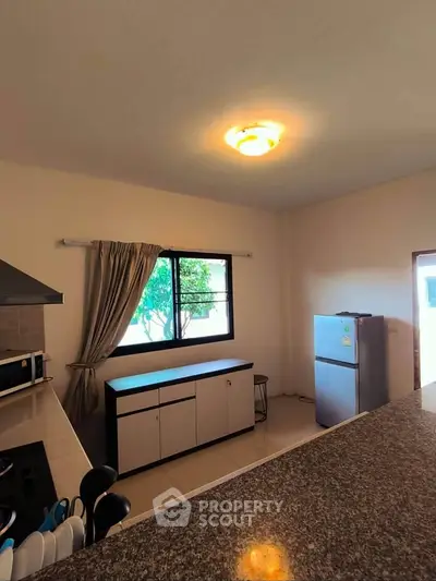 Spacious kitchen with modern appliances and ample natural light