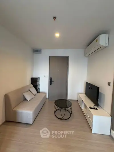 Modern living room with sleek furniture and air conditioning, perfect for urban living.