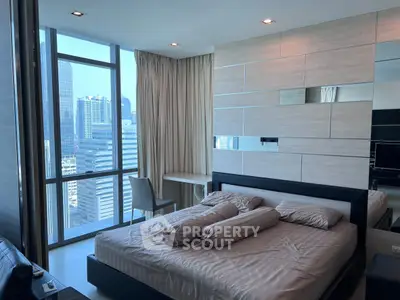 Luxurious bedroom with stunning city view, modern decor, and ample natural light in high-rise apartment.