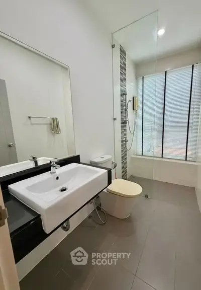 Modern bathroom with sleek fixtures and glass shower enclosure