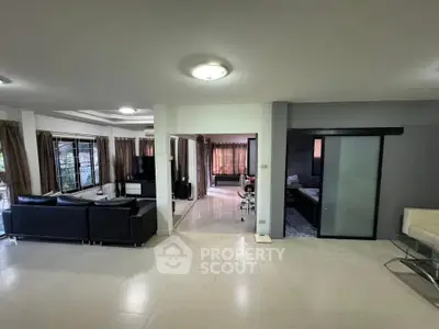 Spacious modern living room with sleek furniture and large windows for natural light.