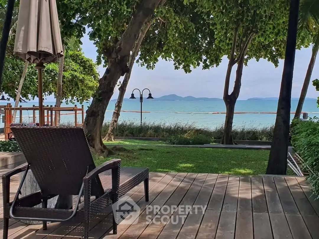 Stunning beachfront property with lush greenery and ocean view, perfect for relaxation and luxury living.
