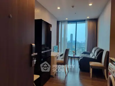 Modern living room with city view, featuring sleek furniture and large windows for natural light.