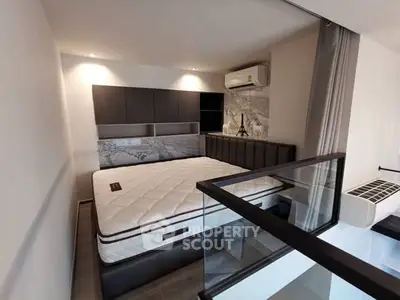 Modern bedroom with stylish decor and air conditioning in a contemporary apartment.