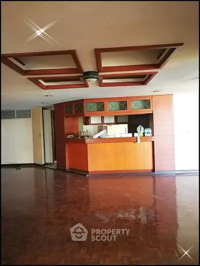 Spacious living room with wooden flooring and stylish ceiling design