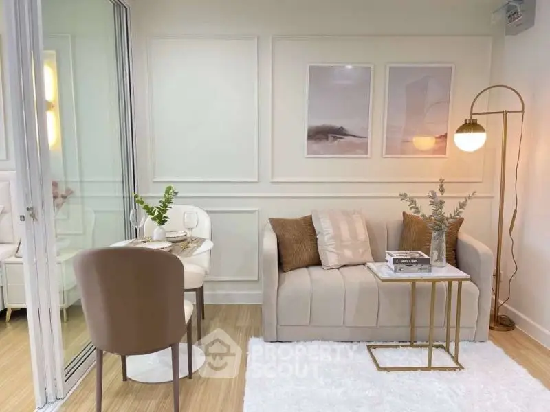 Chic modern living room with cozy sofa, elegant decor, and stylish dining area.