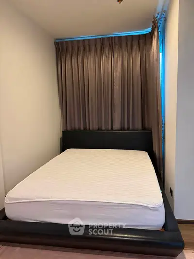 Cozy bedroom with elegant curtains and modern bed frame, perfect for restful nights.