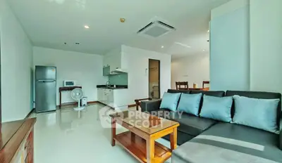 Spacious modern living room with open kitchen and stylish furniture in a bright apartment.