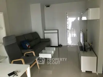 Modern living room with sleek furniture and glossy flooring