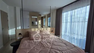 Cozy bedroom with large windows and modern decor, perfect for relaxation and comfort.