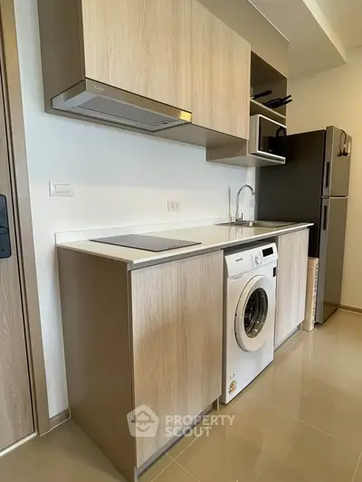 Modern kitchen with integrated washing machine and sleek cabinetry