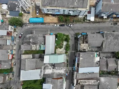 Aerial view of urban residential area with multiple buildings and streets.
