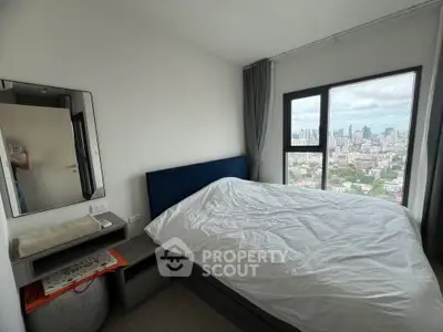 Cozy bedroom with city view in modern high-rise apartment