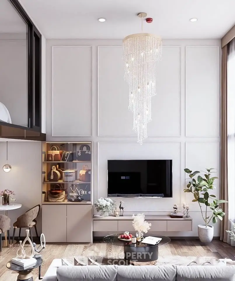 Luxurious living room with elegant chandelier and modern decor, featuring a stylish TV setup and cozy seating area.