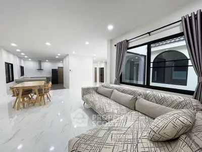 Spacious modern living room with open kitchen and elegant decor