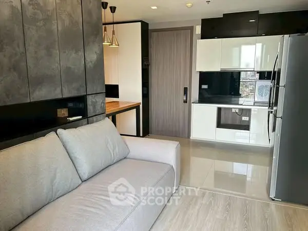 Modern open-plan living room with sleek kitchen and stylish decor