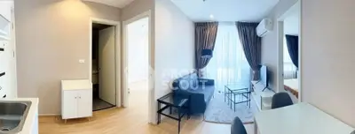 Modern living room with cozy seating and natural light in a stylish apartment.