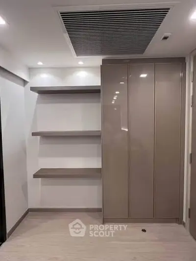 Modern storage space with sleek shelves and cabinets in a contemporary apartment.
