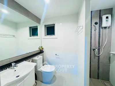 Modern bathroom with sleek fixtures and shower in contemporary home.