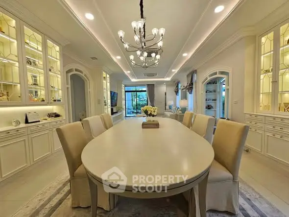 Elegant dining room with chandelier and built-in cabinets, perfect for entertaining guests.