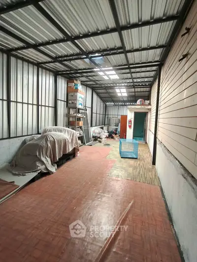 Spacious storage area with metal roofing and ample shelving space.