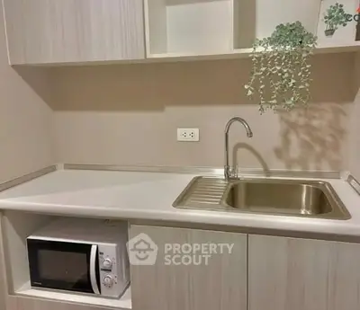 Modern kitchen with sleek cabinetry and built-in microwave