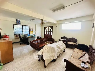Spacious living room with traditional wooden furniture and natural light