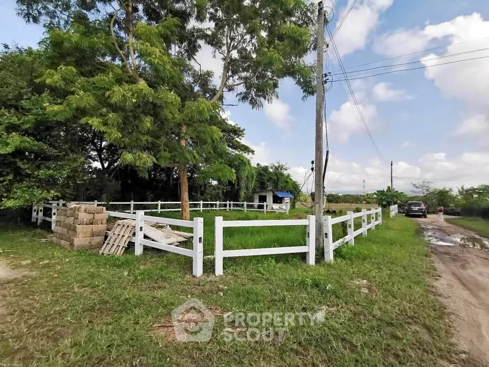 Scenic rural property with lush greenery and white fencing, ideal for development or agriculture.